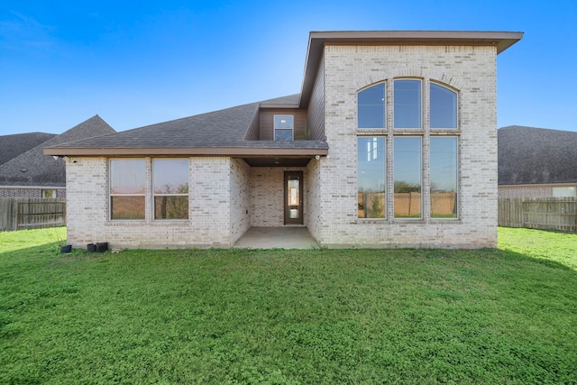 back of house featuring a patio and a lawn