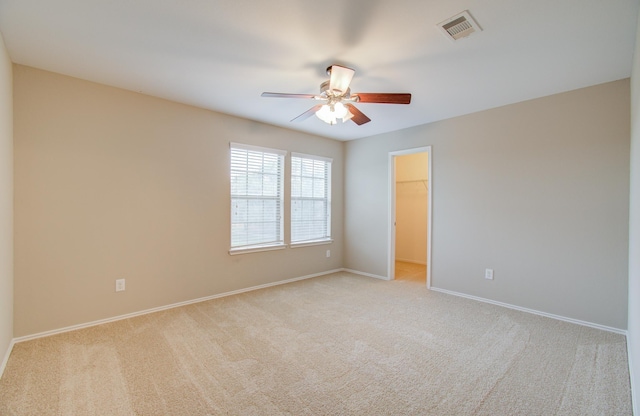 spare room with light carpet and ceiling fan