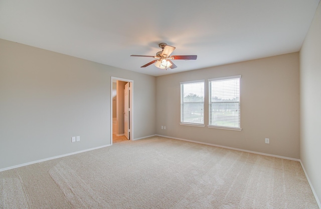 spare room with light carpet and ceiling fan