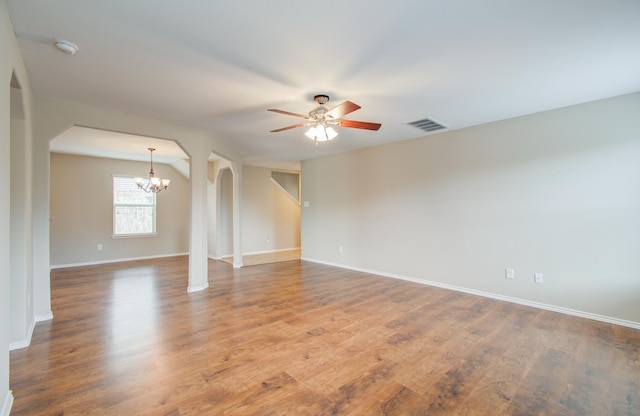 spare room with ceiling fan with notable chandelier and hardwood / wood-style flooring