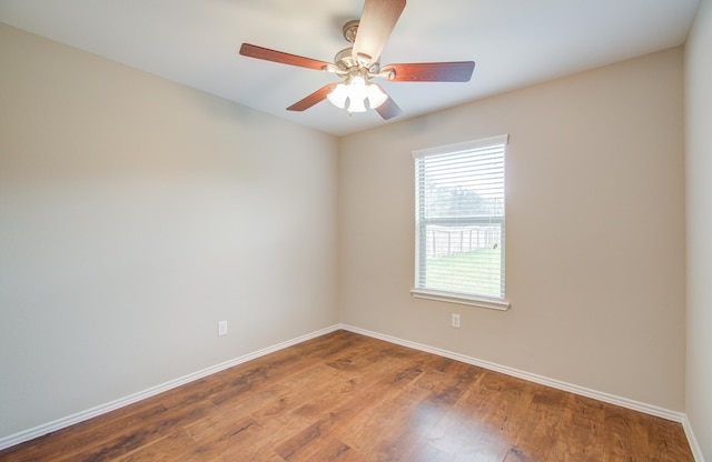 spare room with ceiling fan and wood-type flooring