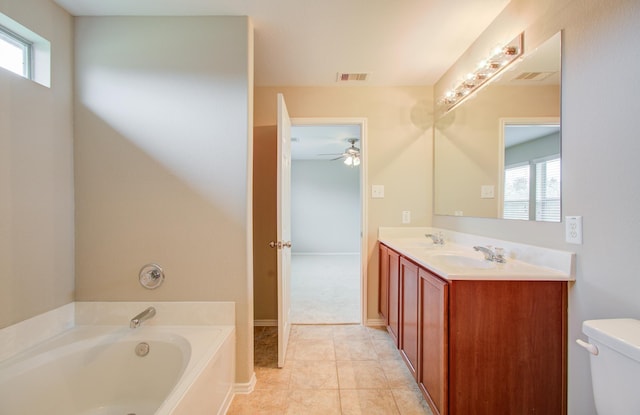 bathroom with ceiling fan, tile patterned floors, toilet, a bathtub, and vanity