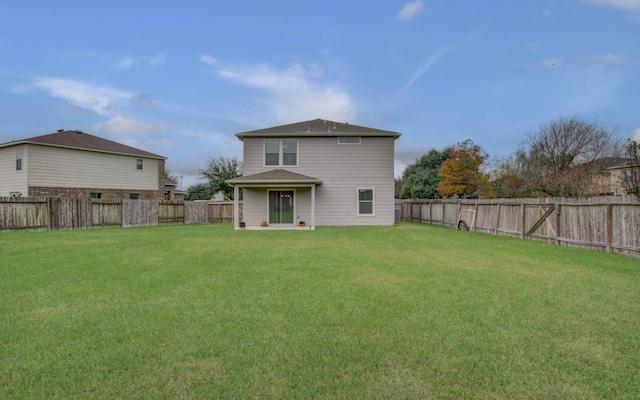 rear view of house with a yard