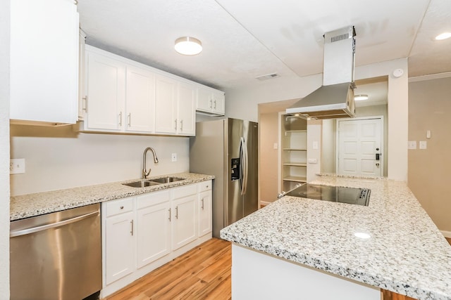 kitchen with white cabinets, sink, light hardwood / wood-style flooring, island exhaust hood, and stainless steel appliances