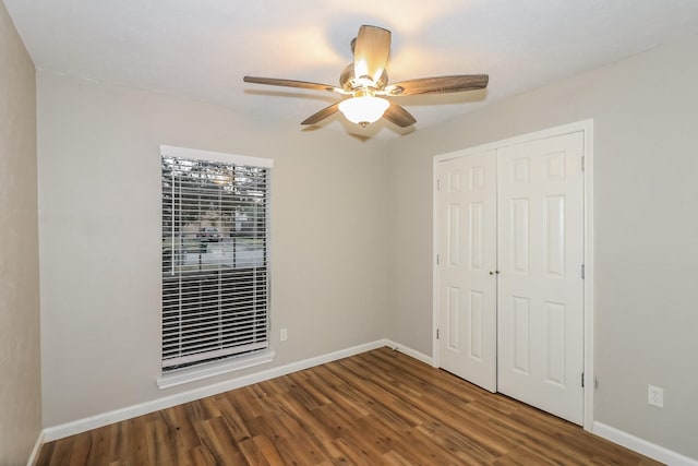 unfurnished bedroom with hardwood / wood-style floors, ceiling fan, and a closet