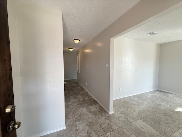 hallway with a textured ceiling