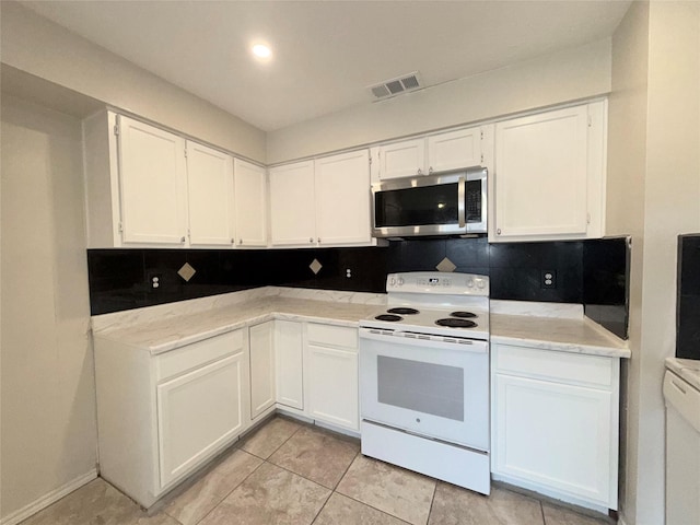 kitchen with white cabinets, white electric range, tasteful backsplash, and light tile patterned flooring