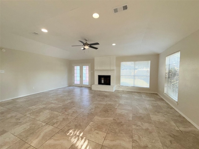 unfurnished living room with a fireplace and ceiling fan