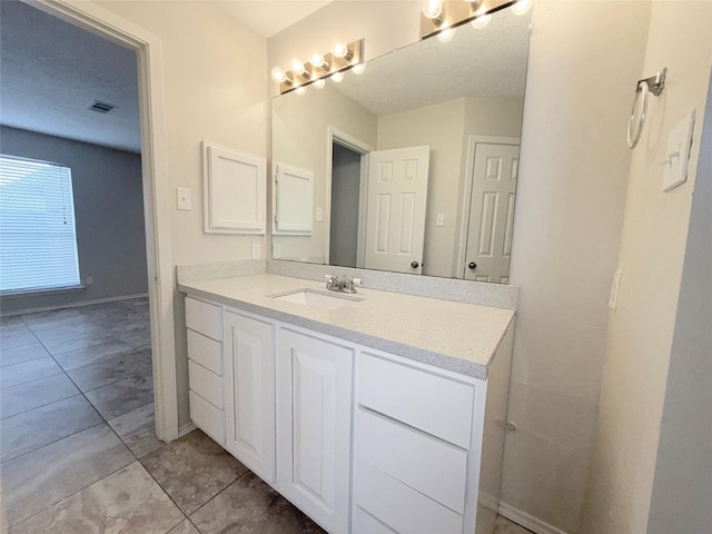 bathroom featuring tile patterned floors and vanity