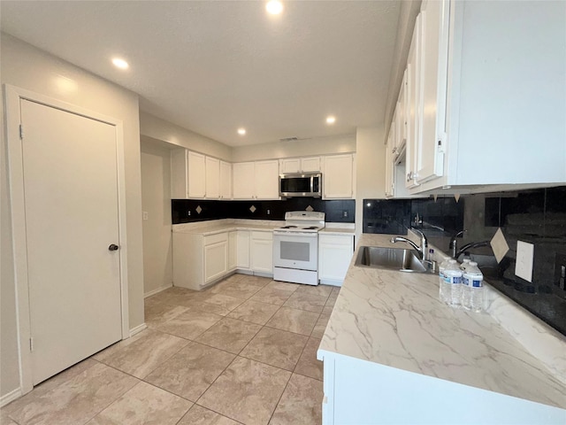 kitchen featuring white range with electric stovetop, decorative backsplash, sink, and white cabinets