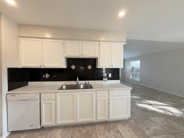 kitchen with backsplash, dishwasher, white cabinets, and sink