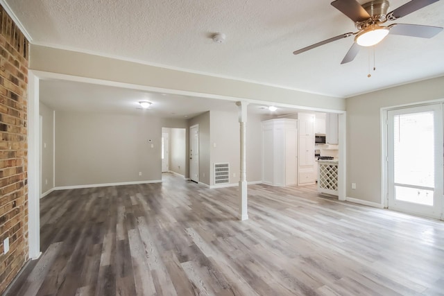 interior space featuring a textured ceiling, hardwood / wood-style flooring, and ceiling fan