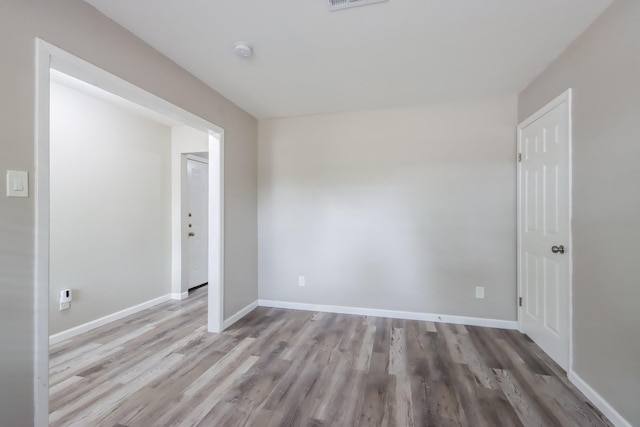 spare room featuring light wood-type flooring