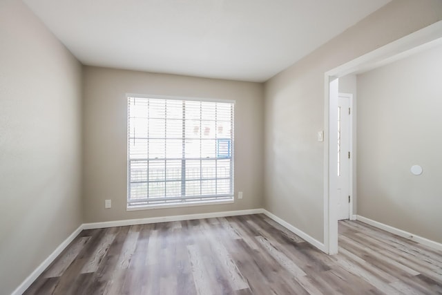 spare room with hardwood / wood-style floors