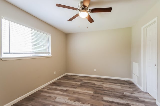 spare room with hardwood / wood-style flooring and ceiling fan