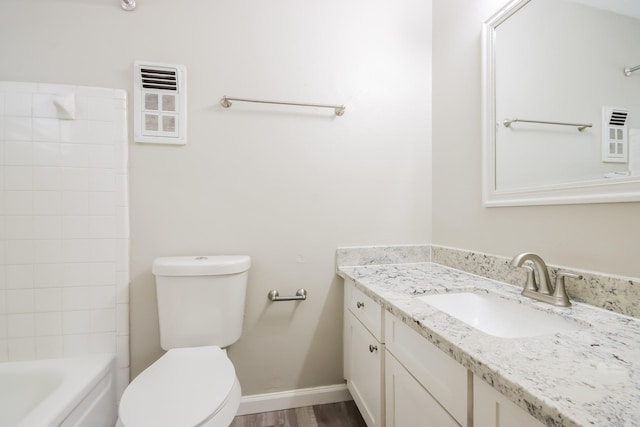 bathroom with wood-type flooring, vanity, and toilet