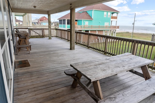 deck featuring a water view and a sunroom