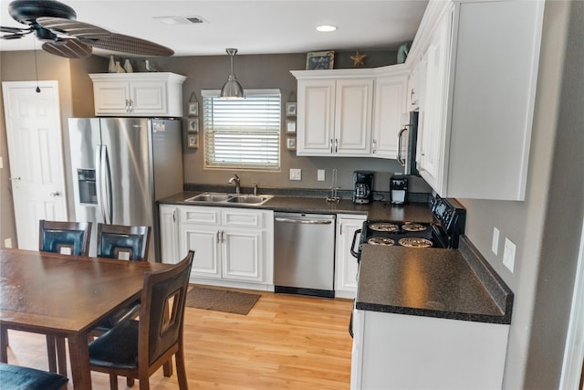 kitchen with white cabinets, sink, light hardwood / wood-style flooring, ceiling fan, and appliances with stainless steel finishes