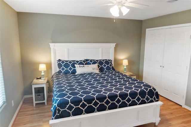 bedroom with ceiling fan, light hardwood / wood-style floors, and a closet