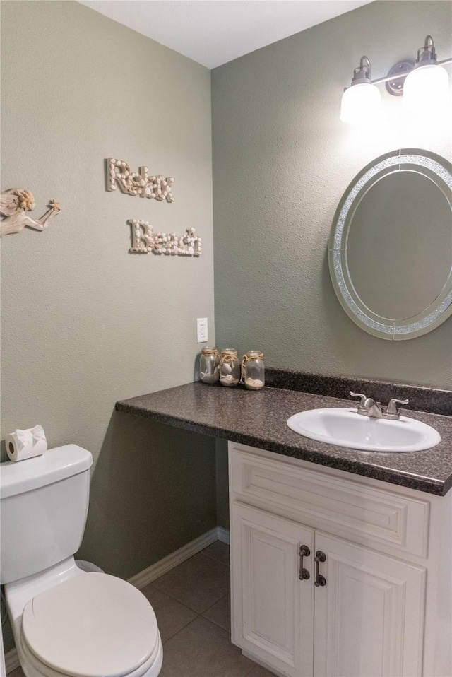 bathroom with tile patterned floors, vanity, and toilet