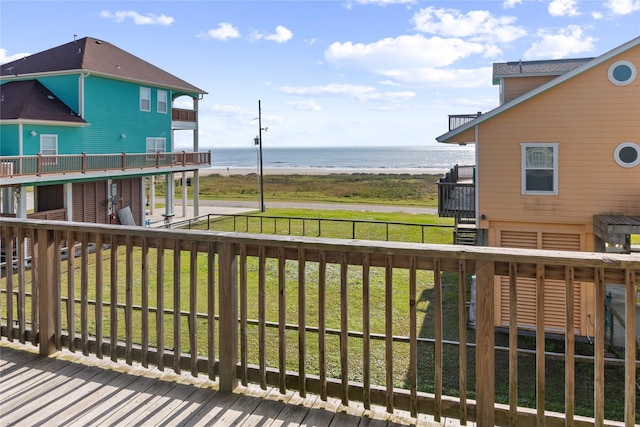 deck featuring a lawn and a water view