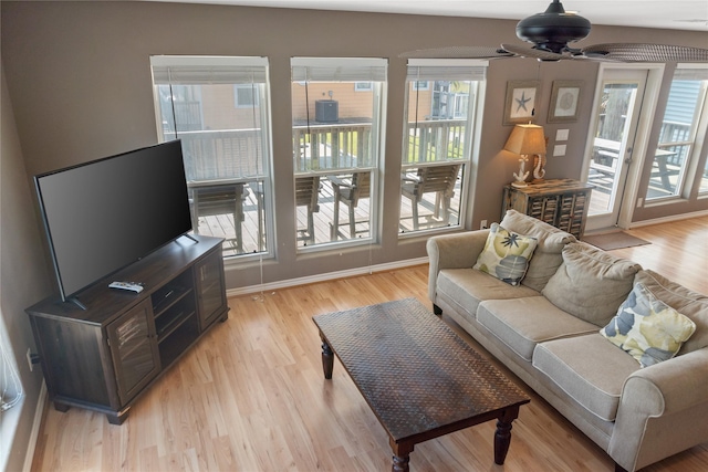 living room featuring ceiling fan, a healthy amount of sunlight, and light hardwood / wood-style floors