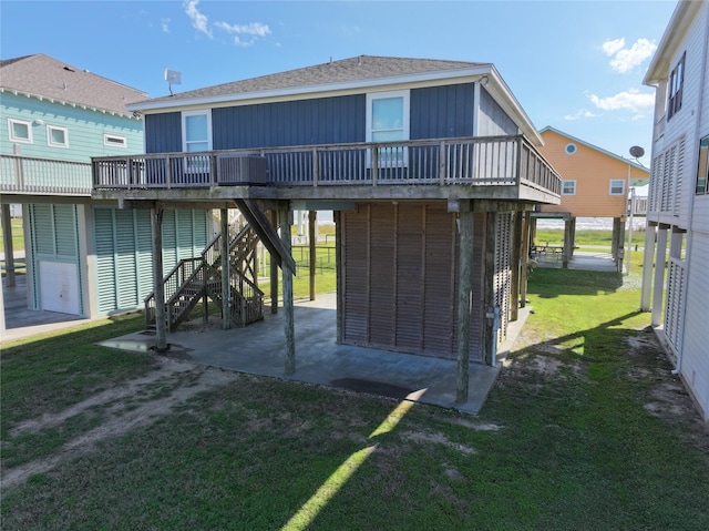 rear view of property featuring a lawn and a wooden deck