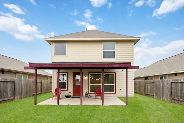 rear view of house featuring a lawn and a patio area