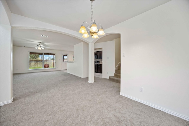 unfurnished living room featuring ceiling fan with notable chandelier and light colored carpet