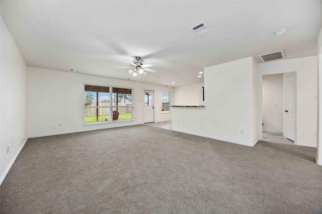 unfurnished living room featuring ceiling fan and light carpet