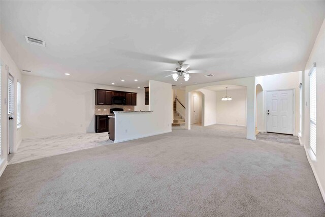 unfurnished living room with ceiling fan and light carpet