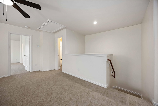 unfurnished room featuring light colored carpet and ceiling fan