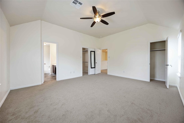 unfurnished bedroom featuring ceiling fan, carpet floors, and vaulted ceiling