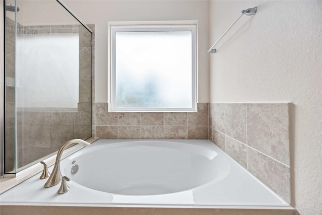 bathroom with a tub to relax in