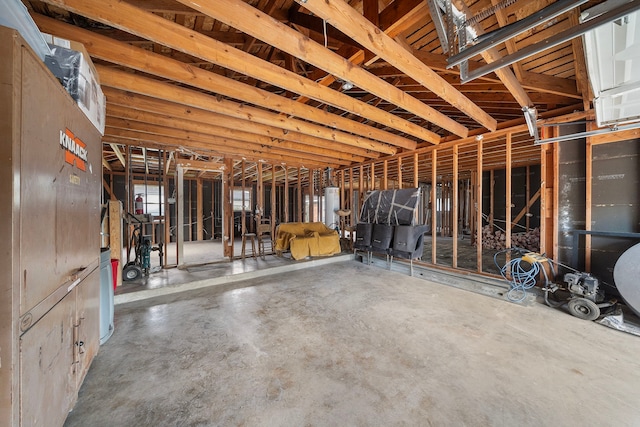 miscellaneous room with concrete floors and water heater