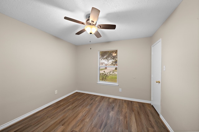 unfurnished room featuring ceiling fan, dark wood-type flooring, and a textured ceiling