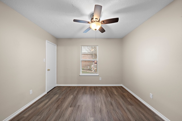 empty room featuring ceiling fan, dark hardwood / wood-style flooring, and a textured ceiling