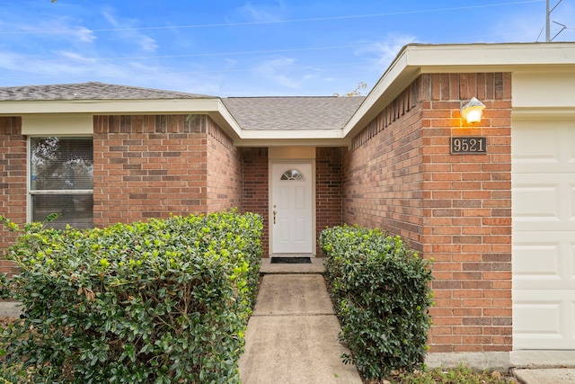 view of exterior entry with a garage