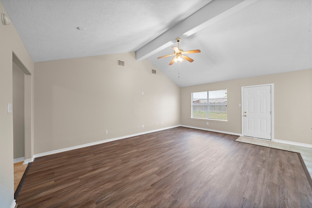 spare room featuring dark hardwood / wood-style floors, lofted ceiling with beams, a textured ceiling, and ceiling fan