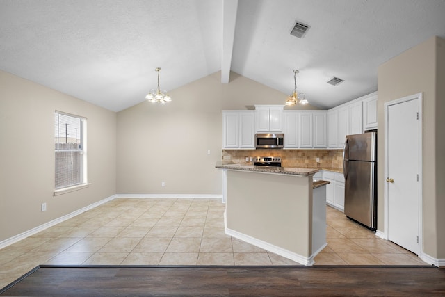 kitchen featuring hanging light fixtures, light hardwood / wood-style flooring, vaulted ceiling with beams, white cabinetry, and stainless steel appliances