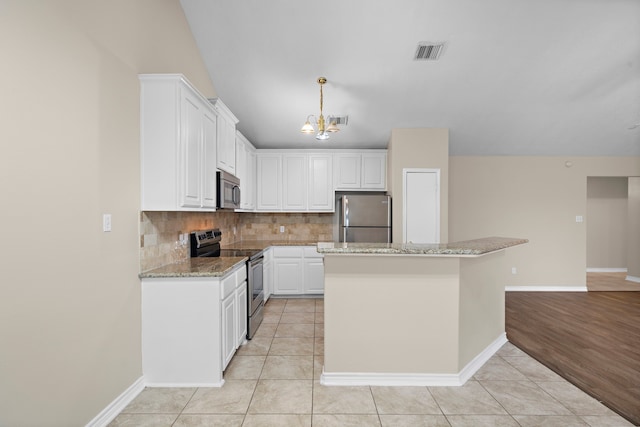 kitchen featuring decorative backsplash, light stone counters, stainless steel appliances, white cabinets, and light hardwood / wood-style floors