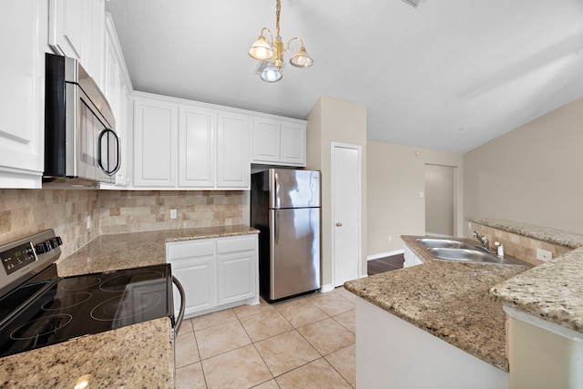 kitchen with decorative light fixtures, stainless steel appliances, and white cabinetry