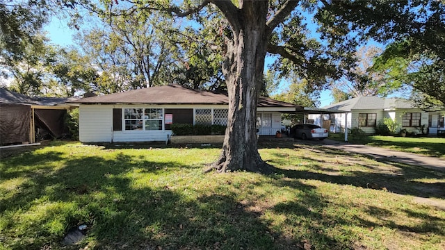 ranch-style house with a front lawn and a carport