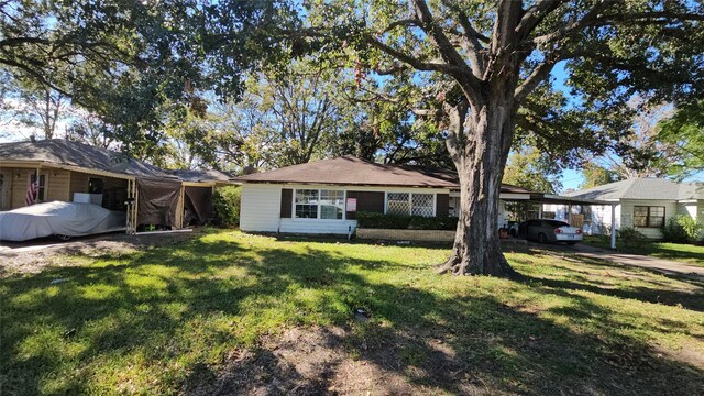 single story home with a carport and a front yard