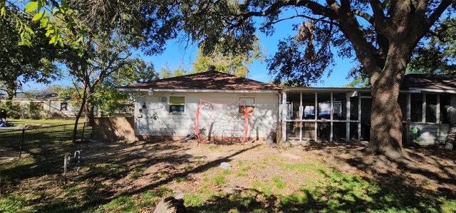 back of house featuring a sunroom