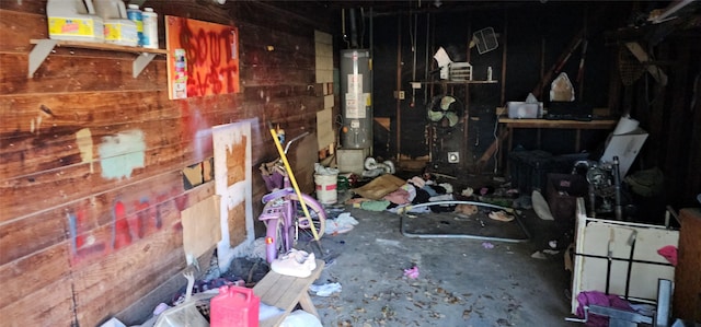 misc room with gas water heater and concrete floors