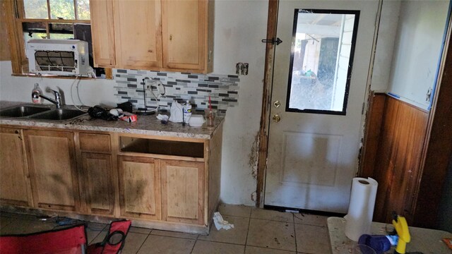 kitchen featuring light tile patterned flooring, decorative backsplash, and sink