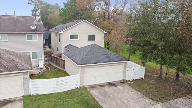 view of front of home with a front yard and a garage