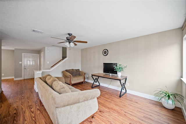 living room with ceiling fan and hardwood / wood-style floors