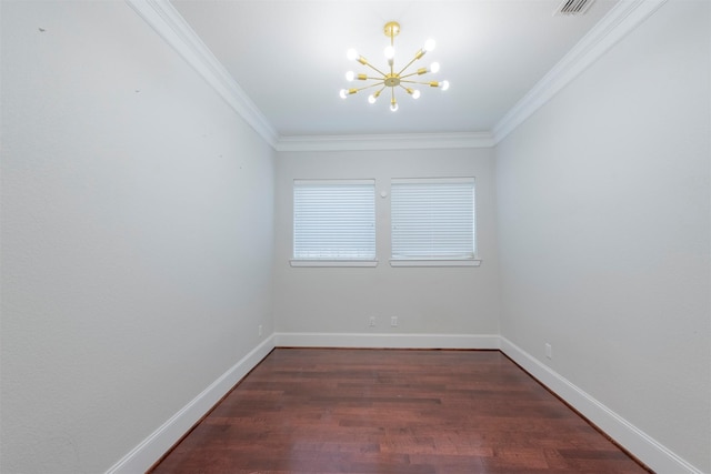 spare room featuring dark hardwood / wood-style flooring, an inviting chandelier, and ornamental molding